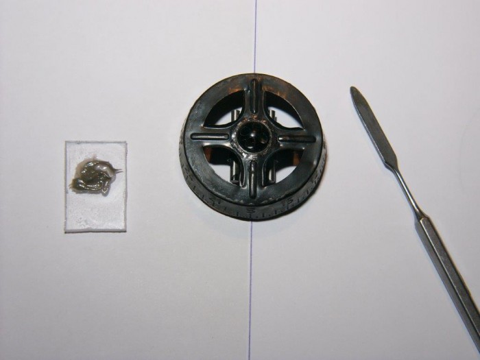 Das Magnetsystem und die Kompassrose wurden mit ölresitentem Zweikomponentenkleber verklebt. Die Ausrichtung zwischen beiden Teilen muß stimmen, dazu dient der Strich auf dem Untergrund. Den hatte ich vorher ausgepeilt.  Die Kompassrose wurde durch Aufbringen von einigen Tropfen Kleber an den entsprechenden Stellen anschließend waagrecht ausbalanciert.