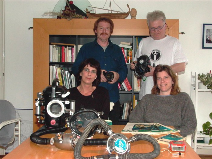 In der vorderen Reihe, v. l. n.r. Meine Frau Sabine, daneben Dan's damalige Freundin Linda Falge.<br />Hinten links steht Dan.  Alle Gerätschaften auf dem Tisch gehören ihm, ich hatte damals nur Die Rollei 3003 und einen Duomat.  Nach Dan's Besuch sollte sich das bald ändern.